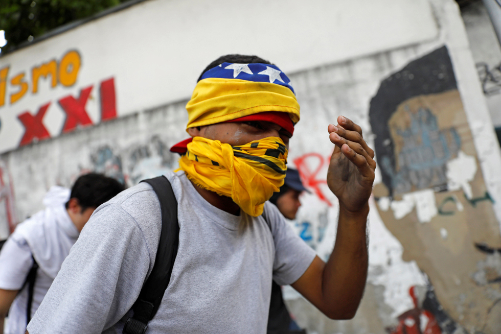 A demonstrator reacts as the riot police clashes with opposition supporters during a rally in Caracas, Venezuela, April 8, 2017. REUTERS/Carlos Garcia Rawlins