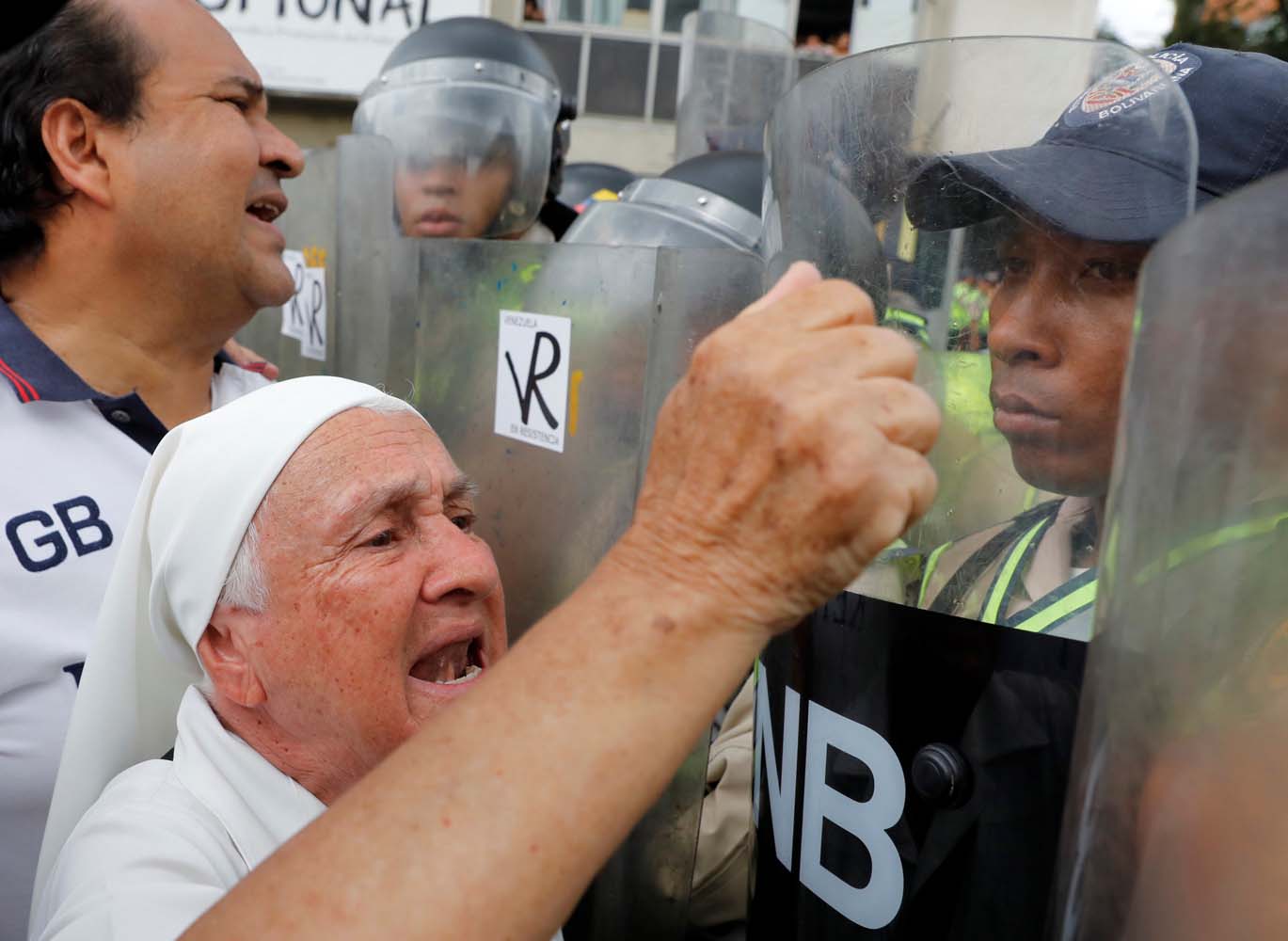 Elderly opposition supporters confront riot security forces while rallying against President Nicolas Maduro in Caracas, Venezuela, May 12, 2017. REUTERS/Carlos Garcia Rawlins