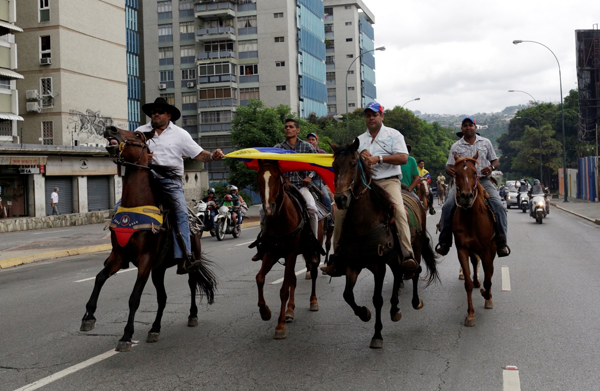 Demonstrators ride on horses and take part in a nationwide protest against President Nicolas Maduro government, in Caracas, Venezuela, May 13, 2017. REUTERS/Marco Bello