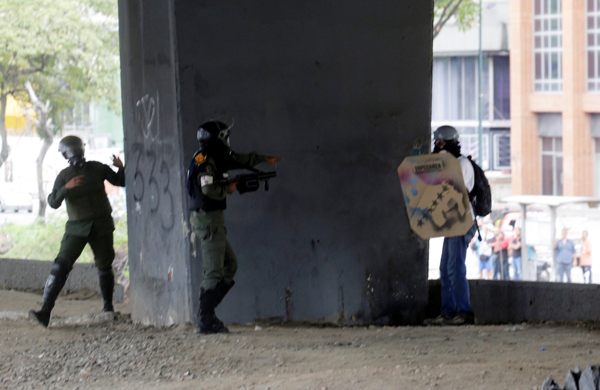 A demonstrator is detained by riot security forces during a protest against Venezuela's President Nicolas Maduro's government in Caracas, Venezuela, May 13, 2017. REUTERS/Marco Bello