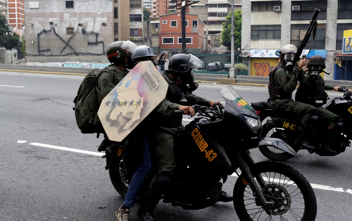 A demonstrator is detained by riot security forces during a protest against Venezuela's President Nicolas Maduro's government in Caracas, Venezuela, May 13, 2017. REUTERS/Marco Bello