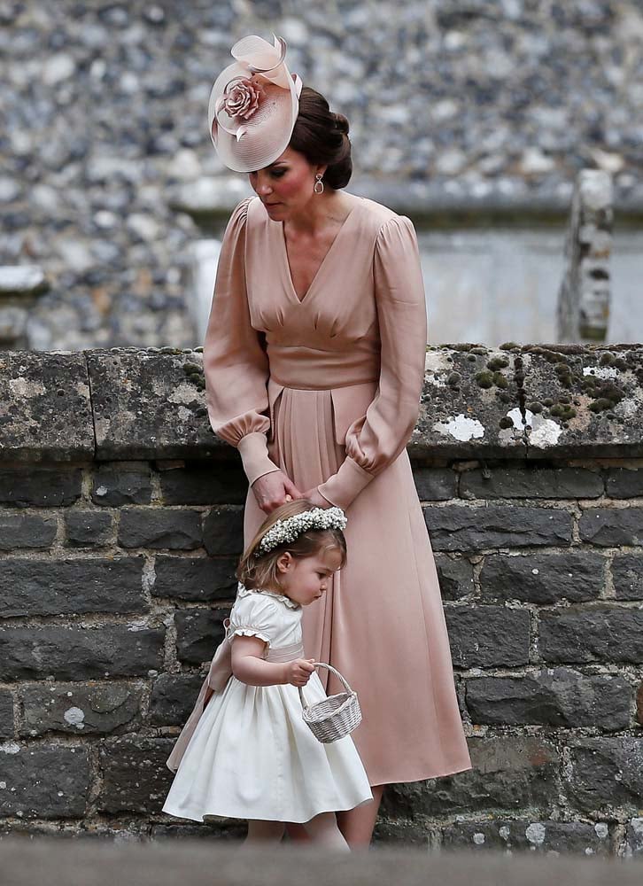 Britain's Catherine, Duchess of Cambridge stands with her daughter Princess Charlotte, a bridesmaid, following the wedding of her sister Pippa Middleton to James Matthews at St Mark's Church in Englefield, west of London, on May 20, 2017. REUTERS/Kirsty Wigglesworth/Pool