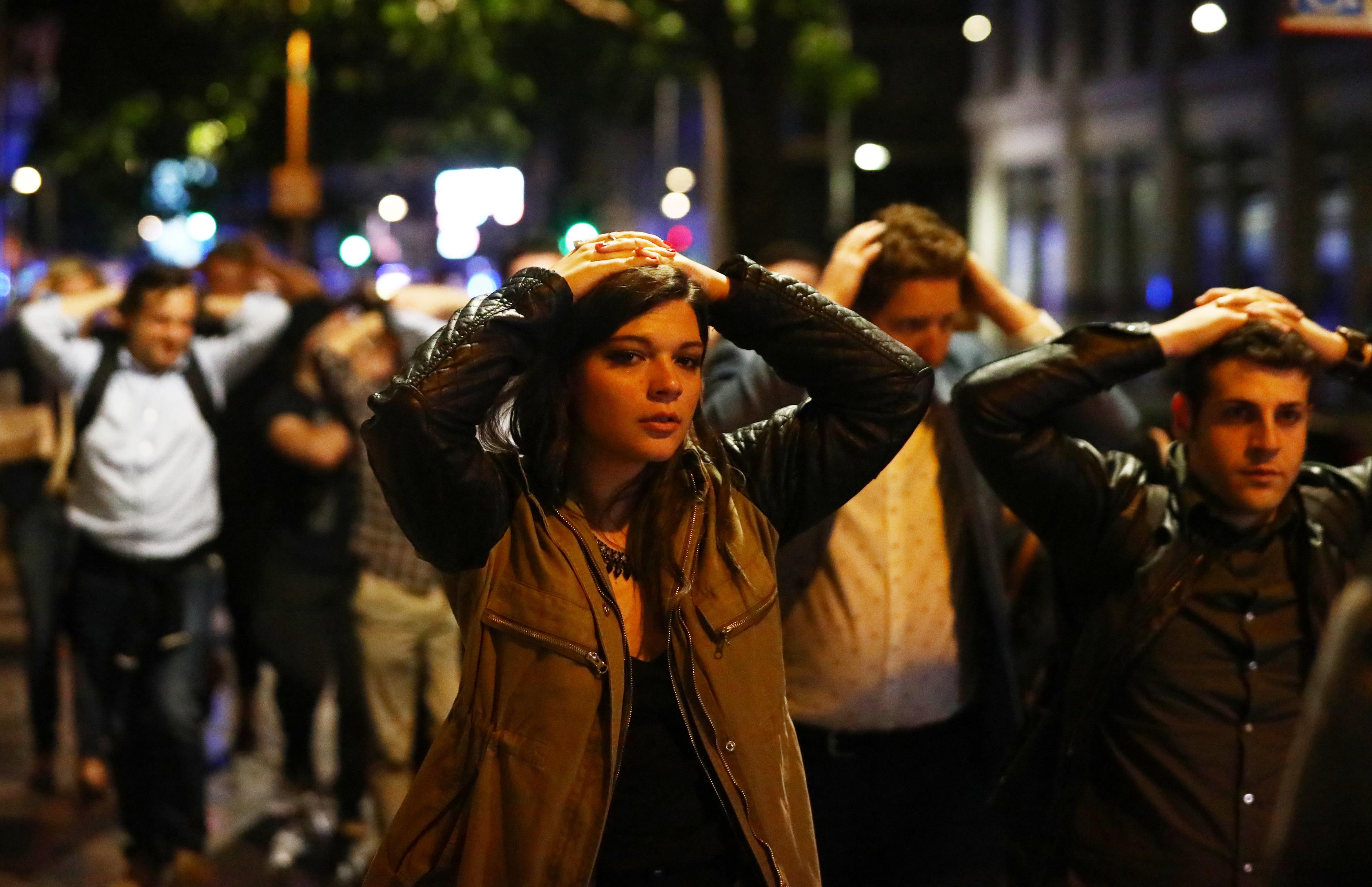 People leave the area with their hands up after an incident near London Bridge in London, Britain June 4, 2017. REUTERS/Neil Hall