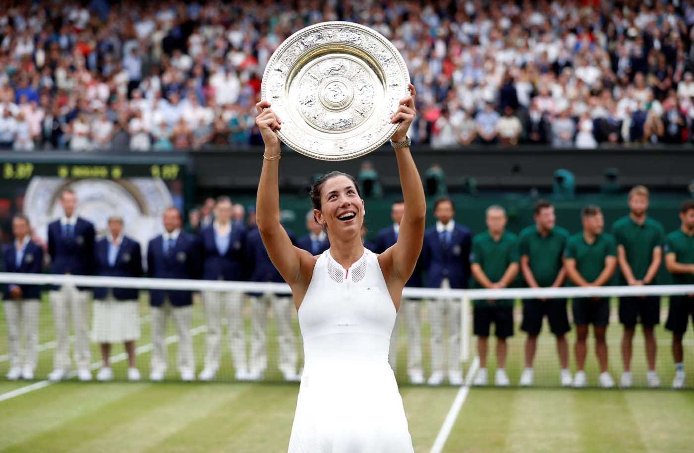 Tennis - Wimbledon - London, Britain - July 15, 2017 Spain’s Garbine Muguruza poses with the trophy as she celebrates winning the final against Venus Williams of the U.S. REUTERS/Matthew Childs