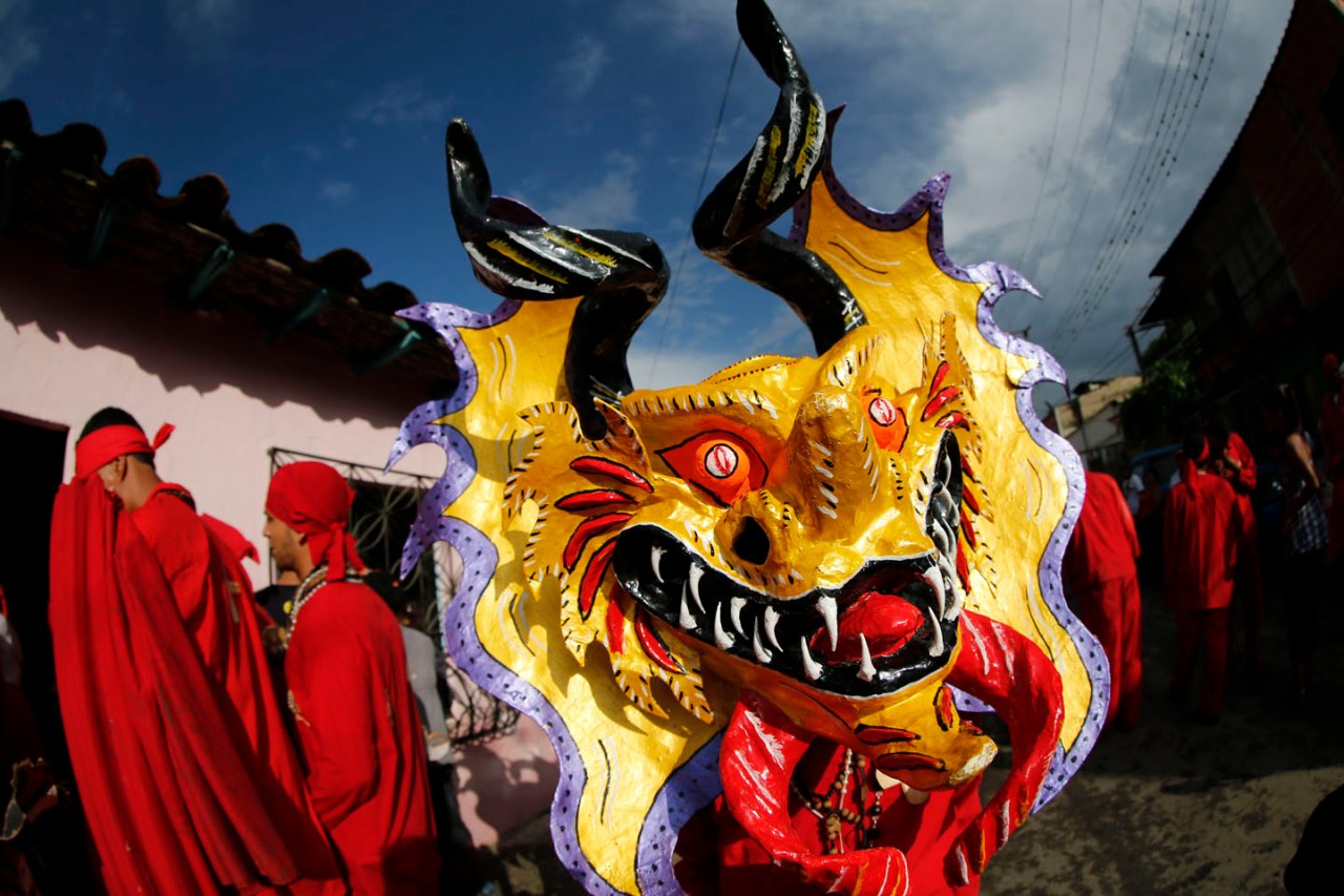 A participant of the “Diablos Danzantes” of Yare wears a mask as they ...