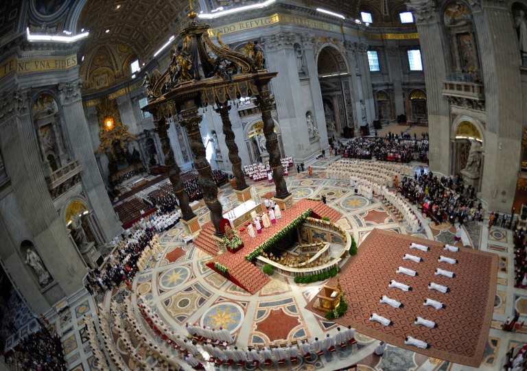 New priests lay on the floor as Pope Francis leads their ordination
