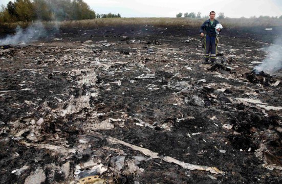 Emergencies Ministry member walks at the site of a Malaysia Airlines Boeing 777 plane crash near the settlement of Grabovo in the Donetsk region