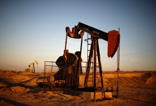 Oil derricks are seen at sunrise near Bakersfield