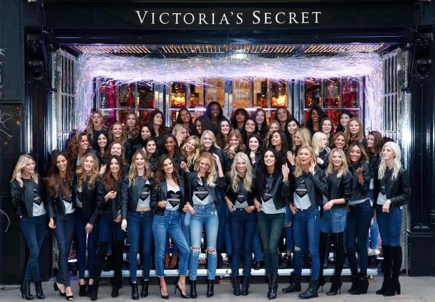 Models pose for a group photograph outside the Victoria's Secret shop