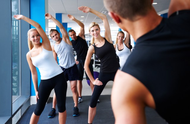 Fitness Instructor Leading Stretches