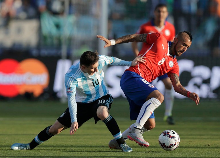 Chile's Vidal is challenged by Argentina's Messi during ...