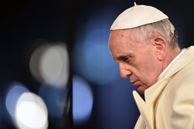 Pope Francis leads the celebration of the Way of the Cross on Good Friday on March 29, 2013 at the Colosseum in Rome. Pope Francis presided over his first Good Friday which will culminate in a torch-lit procession at Rome's Colosseum and prayers for peace in a Middle East "torn apart by injustice and conflicts".     AFP PHOTO / GABRIEL BOUYS