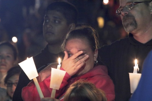 ROSEBURG, OREGON - OCTOBER 1: Denizens of Roseburg gather at a candlelight vigil for the victims of a shooting October 1, 2015 in Roseburg, Oregon. According to reports, 10 were killed and 20 injured when a gunman opened fire at Umpqua Community College in Roseburg, Oregon.   Michael Lloyd/Getty Images/AFP