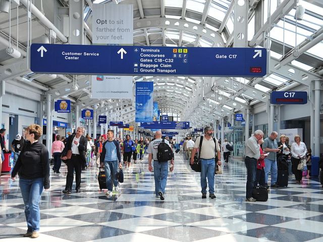 Travellers walk down a concourse at Chic