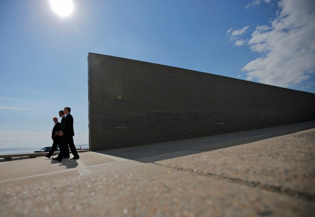 U.S. President Barack Obama (C) and Argentina's President Mauricio Macri (R) visit with Argentine photographer Marcelo Brodsky the Parque de la Memoria (Remembrance Park), where they honored victims of Argentina's Dirty War on the 40th anniversary of the 1976 coup that initiated that period of military rule, in Buenos Aires, March 24, 2016. REUTERS/Carlos Barria