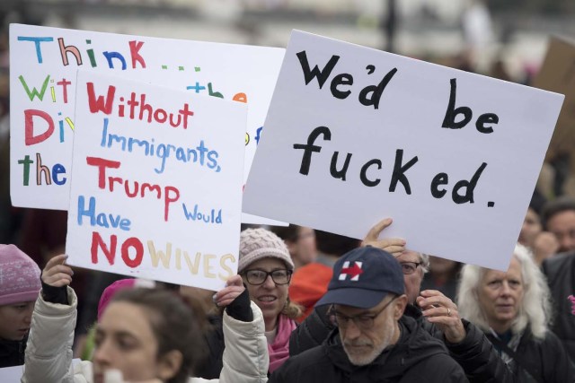 Demonstrators with placards march past the US Capitol during the Women's March on Washington in Washington, DC, January 21, 2017. Hundreds of thousands of protesters spearheaded by women's rights groups demonstrated across the US to send a defiant message to US President Donald Trump. / AFP PHOTO / JIM WATSON