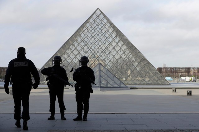 French police secure the site near the Louvre Pyramid in Paris, France, February 3, 2017 after a French soldier shot and wounded a man armed with a knife after he tried to enter the Louvre museum in central Paris carrying a suitcase, police sources said. REUTERS/Christian Hartmann