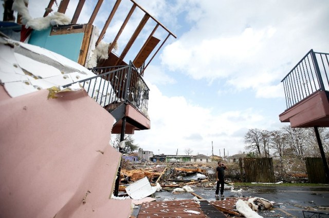 NEW ORLEANS, LA - FEBRUARY 07: A man walks through the debris of once was a motel on Chef Menture Ave after a tornado touched down on February 7, 2017 in New Orleans, Louisiana. According to the weather service, 25 people were injured in the aftermath of the tornado. Sean Gardner/Getty Images/AFP