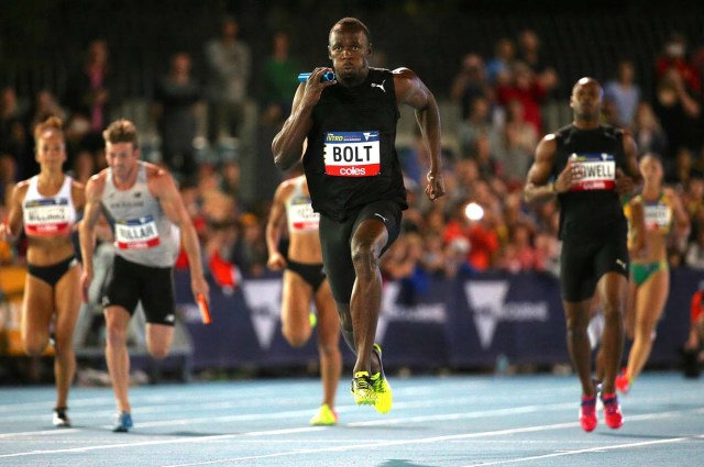 Jamaica's Olympic champion Usain Bolt runs after receiving the baton from team mate and compatriot Asafa Powell during the final night of the Nitro Athletics series at the Lakeside Stadium in Melbourne, Australia, February 11, 2017. REUTERS/Hamish Blair