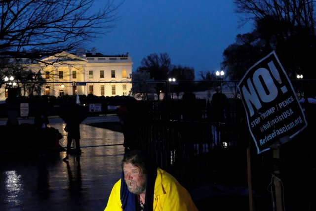 An protester against U.S. President Donald Trump sits outside the White House ahead of a protest rally at which Rosie O'Donnell was slated to speak, in Washington