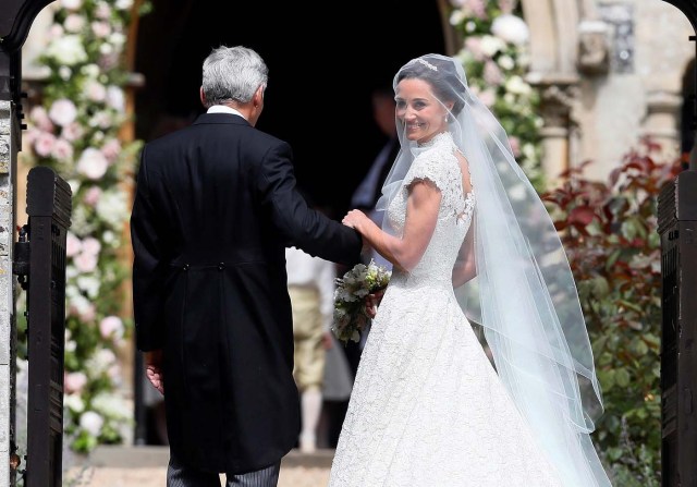 Pippa Middleton, the sister of Britain's Catherine, Duchess of Cambridge, arrives with her father Michael Middleton for her wedding to James Matthews at St Mark's Church in Englefield, west of London, on May 20, 2017. REUTERS/Kirsty Wigglesworth/Pool
