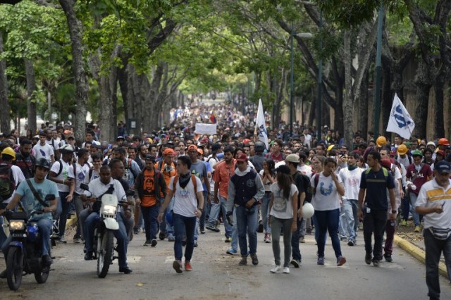 Venezuela's Central University students march to the education ministry, during a protest against President Nicolas Maduro, in Caracas on May 8, 2017. Venezuela's opposition mobilized Monday in fresh street protests against President Nicolas Maduro's efforts to reform the constitution in a deadly political crisis. Supporters of the opposition Democratic Unity Roundtable (MUD) gathered in eastern Caracas to march to the education ministry under the slogan "No to the dictatorship."  / AFP PHOTO / FEDERICO PARRA