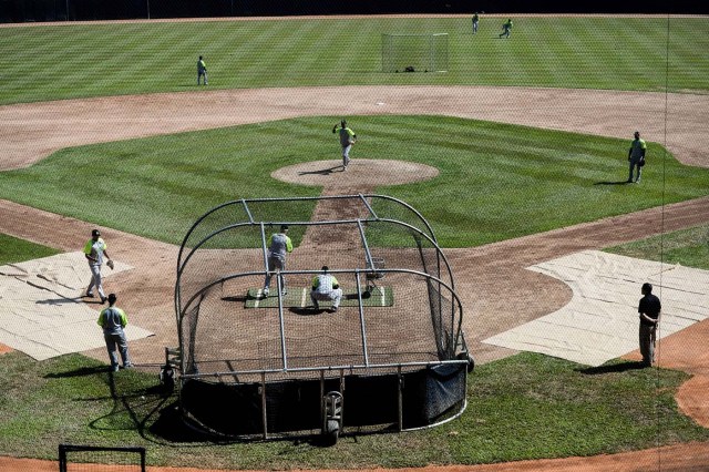 Players of the Venezuelan baseball team Leones del Caracas attend a training session at the Universitario stadium in Caracas, on September 18, 2017. While baseball is Venezuela's national sport, some fans are angry that the government, given the severity of the economic crisis and the political tension, will spend nearly ten million dollars on organizing the upcoming Winter League rather than on imports of food and medicine. / AFP PHOTO / FEDERICO PARRA