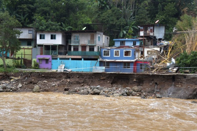 View of a residential area affected by a landslide following the passage of Tropical Storm Nate in Los Anonos neighbourhood, San Jose, on October 6, 2017. A national emergency alert was declared in Costa Rica, where eight people died, including a three-year-old girl, after they were hit by falling trees and mudslides. An alert was issued for people to be wary of crocodiles that might be roaming after rivers and estuaries flooded. / AFP PHOTO / Ezequiel BECERRA