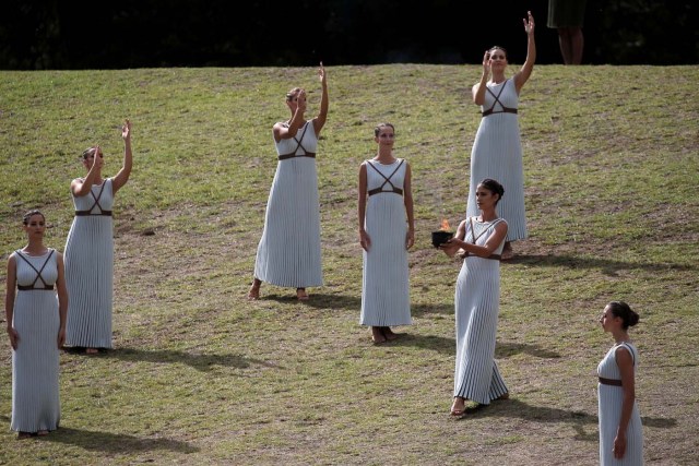 Olympics - Lighting Ceremony of the Olympic Flame Pyeongchang 2018 - Ancient Olympia, Olympia, Greece - October 24, 2017 Actresses with the flame during the Olympic flame lighting ceremony for the Pyeongchang 2018 Winter Olympics REUTERS/Costas Baltas