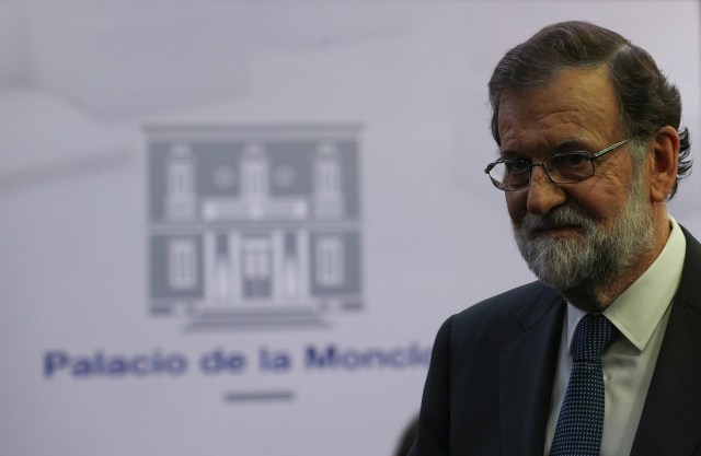 Spain's Prime Minister Mariano Rajoy leaves the conference room after delivering a statement at the Moncloa Palace in Madrid, Spain, October 1, 2017. REUTERS/Sergio Perez