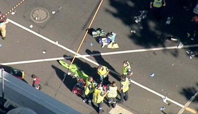 Police and emergency services attend to the scene of an incident involving a vehicle on Flinders Street, as seen from Swanson Street, in Melbourne, Australia December 21, 2017. NINE NETWORK/Reuters TV via REUTERS ATTENTION EDITORS - THIS IMAGE WAS PROVIDED BY A THIRD PARTY. NO RESALES. NO ARCHIVE. AUSTRALIA OUT. NEW ZEALAND OUT. PAPUA NEW GUINEA OUT. NO ACCESS AUSTRALIA, NEW ZEALAND, PAPUA NEW GUINEA-BASED INTERNET SITES, MOBILE PLATFORMS OR SITES OF MEDIA ORGANIZATIONS BASED IN THOSE COUNTRIES, NVO CLIENTS/ SMH.COM.AU/NEWS.COM.AU