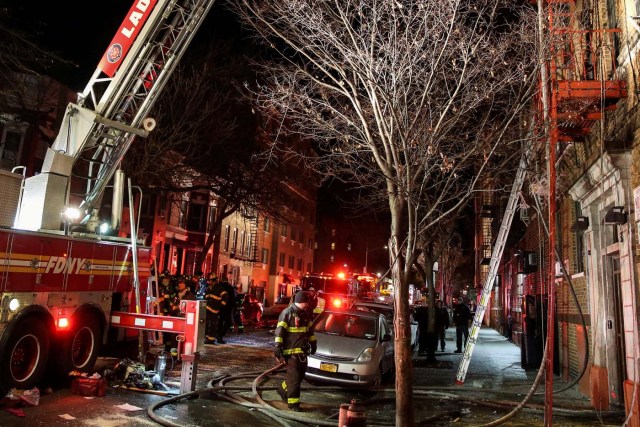 Fire Department of New York (FDNY) personnel work on the scene of an apartment fire in Bronx, New York, U.S., December 28, 2017. REUTERS/Amr Alfiky