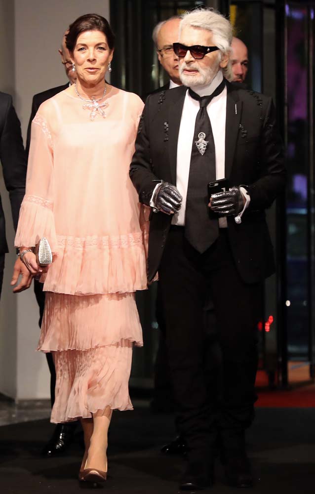 Caroline of Monaco, Princess of Hanover (L) and German fashion designer Karl Lagerfeld arrive for the annual Rose Ball at the Monte-Carlo Sporting Club in Monaco, on March 24, 2018. The Rose Ball is one of the major charity events in Monaco. Created in 1954, it benefits the Princess Grace Foundation. / AFP PHOTO / POOL / VALERY HACHE