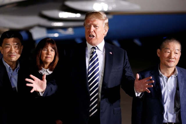 President Donald Trump talks to the media next to the Americans formerly held hostage in North Korea, upon their arrival at Joint Base Andrews, Maryland, U.S., May 10, 2018. REUTERS/Joshua Roberts