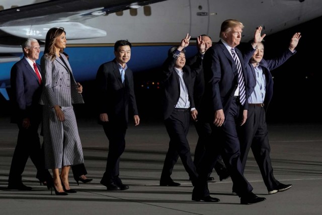The three Americans released from detention in North Korea, Tony Kim, Kim Hak-song and Kim Dong-chul, walk next to U.S.President Donald Trump, first lady Melania Trump, U.S. Vice President Mike Pence, and Secretary of State Mike Pompeo as they arrive at Joint Base Andrews, Maryland, U.S., May 10, 2018. REUTERS/Jonathan Ernst